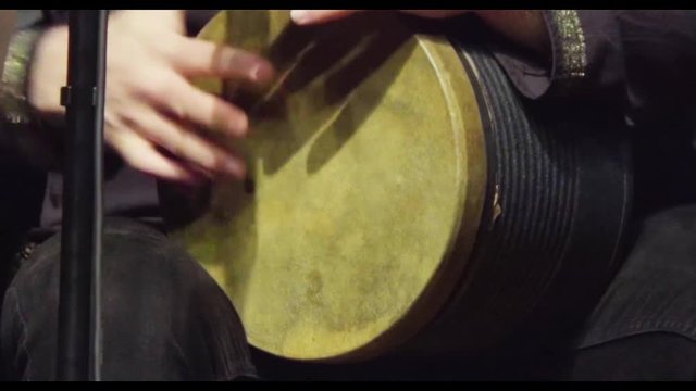 close-up of the artist performing the darbuka
