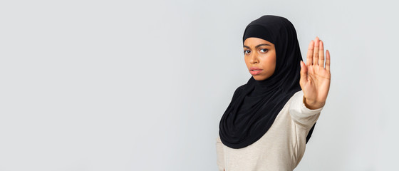 Frightened Afro Muslim Woman In Hijab Rejecting Something With Open Palm