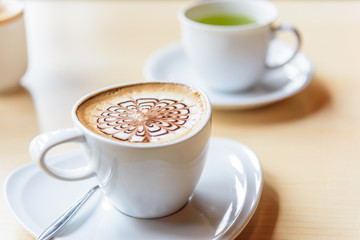 hot coffee on table / hot cappuccino with nice pattern milk foam 