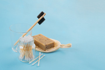 Bath set - sponge luffa, bamboo sticks ear on blue background. Concept less waste