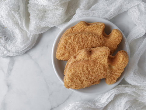 White photoshoot of baulu cakes in the form of goldfish. A malay people called kuih bahulu.