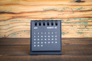 2020 March . Black paper calendar on a wooden table