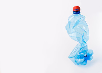 Crumpled or squashed blue plastic bottle isolated on white