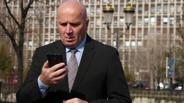 Businessman Waiting Impatiently a Business Meeting Checking His Hand Watch and Mobile Phone