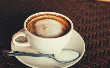 hot cup of coffee on the wood table in the morning.