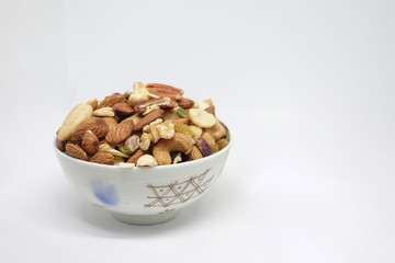 Many nuts in a white background cup