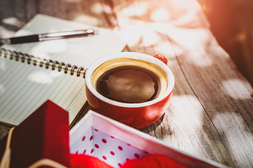 Coffee cup on the table near paper short note.