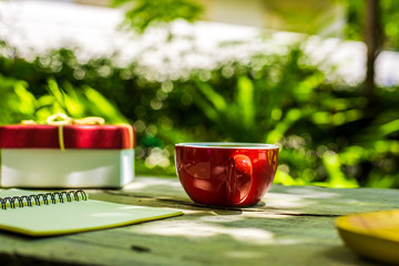 Coffee cup on the table near paper short note.