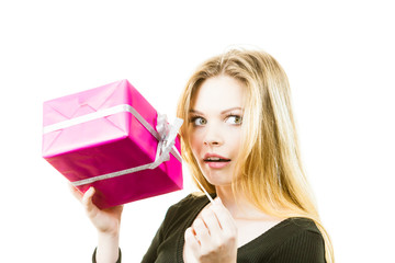 Curious woman holding gift box