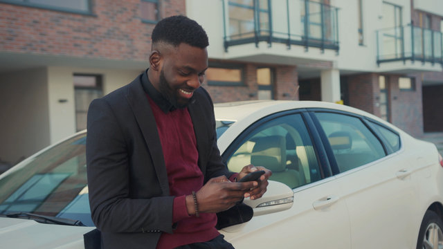 Handsome Young African American Man Stand Speak Use Phone In City Near White Car Technology Sunset Businessmen Busy People Attractive Modern Lifestyle Smartphone Ambitious Mobile Close Up Slow Motion