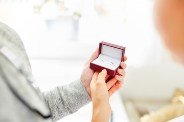 Young couple holds a box with wedding rings