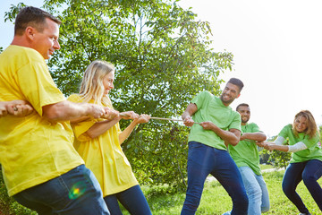 Two athletic teams tug-of-war