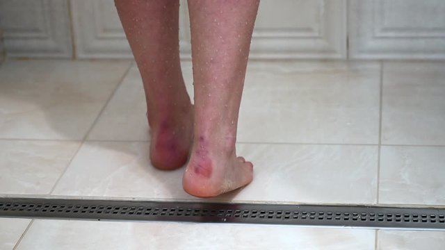 Woman bare feet taking a shower close up