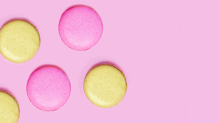 Seamless pattern made of macaroons on the pink background. Flat lay. Food concept.