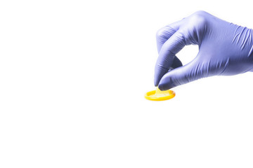 color condom in female hand isolated on a white background