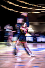 Blurred dancing couple in ballroom