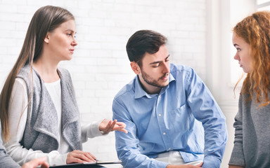 Marriage counselor consulting unhappy couple, giving advice for their relationship