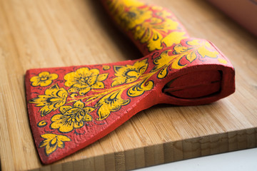 .axe in Khokhloma. An axe painted in Russian folk style. Russian traditions