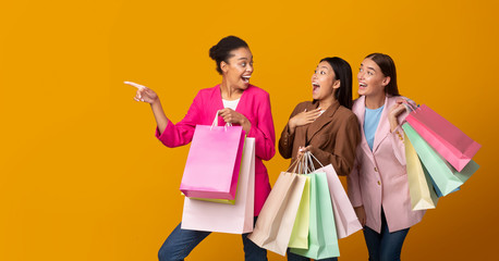 Three Girls On Shopping Holding Bags Pointing Finger, Studio, Panorama