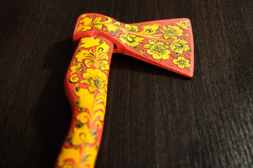 .axe in Khokhloma. An axe painted in Russian folk style. Russian traditions