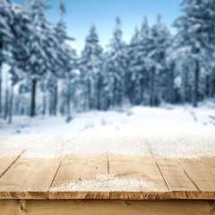 Wooden desk of free space and snow background 