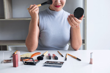 Elegant female Beauty blogger showing testing beauty cosmetic using product makeup tutorial...