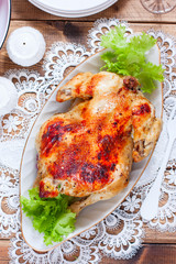 Whole baked chicken with apples on the festive table, selective focus