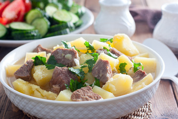 Beef stew with chopped beef in a white bowl, selective focus