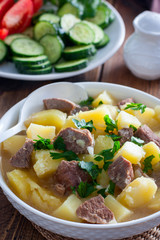 Beef stew with chopped beef in a white bowl, selective focus