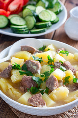Beef stew with chopped beef in a white bowl, selective focus