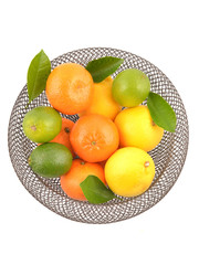 Citrus fruits in basket, isolated on white background. Lemon, orange, lime.
