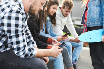 Young people with mobile phone in the city