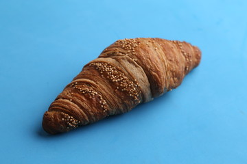 delicious spelled croissant in color background