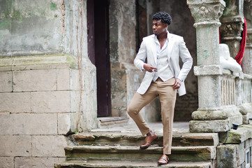 Thoughtful young handsome african american gentleman in formalwear. Black stylish model man in white jacket.