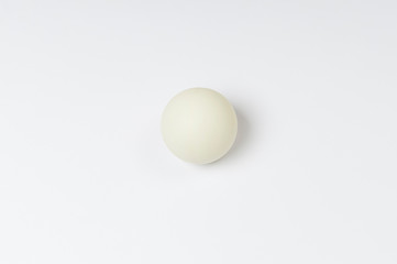 white pinpong ball on a white background top view, space for text on the left and right