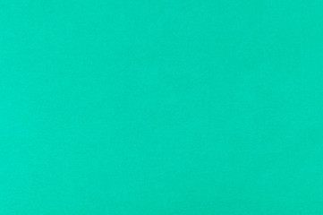 background of an old sheet of emerald-colored paper, top view, paper texture