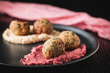 Arabic food, Falafel Humus - Delicious humus with falafel, beautifully arranged on a black plate