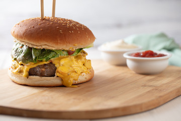 Tasty grilled home made burgers cooking with beef, tomato, cheese, cucumber and lettuce