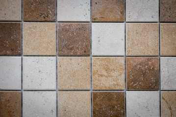 Brown ceramic mosaic on the wall as background