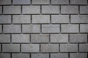 Gray ceramic bricks on the wall as background