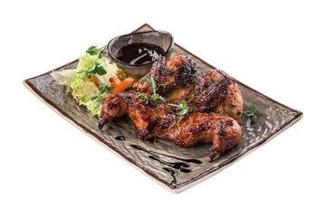 Chicken tobacco with fresh salad and sauce on grey plate isolated on white background