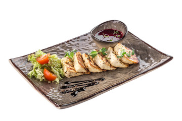 Grilled Halloumi fried cheese with sauce and fresh salad on grey plate isolated on white background