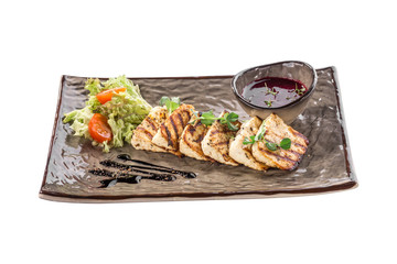 Grilled Halloumi fried cheese with sauce and fresh salad on grey plate isolated on white background