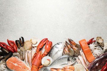Fresh fish and seafood on marble table, flat lay. Space for text - obrazy, fototapety, plakaty