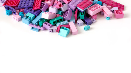 Pile of colored toy bricks isolated on white background.