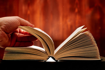 Turn over a thick book. Search for information in a book. Learning concept.