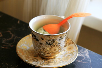 the tea strainer is located in a Cup of hot water