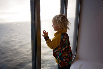 Children, playing on a ferry boat while traveling