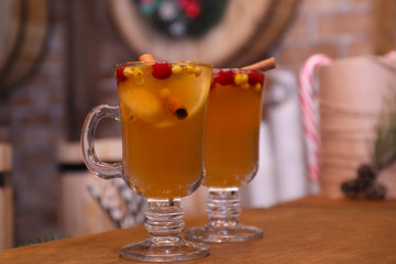 Tasty aromatic mulled wine on wooden table