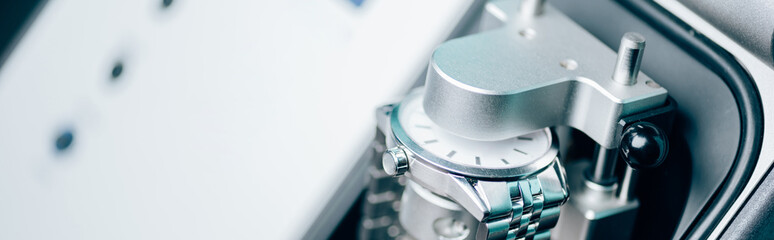Selective focus of wristwatch in watchpress, panoramic shot